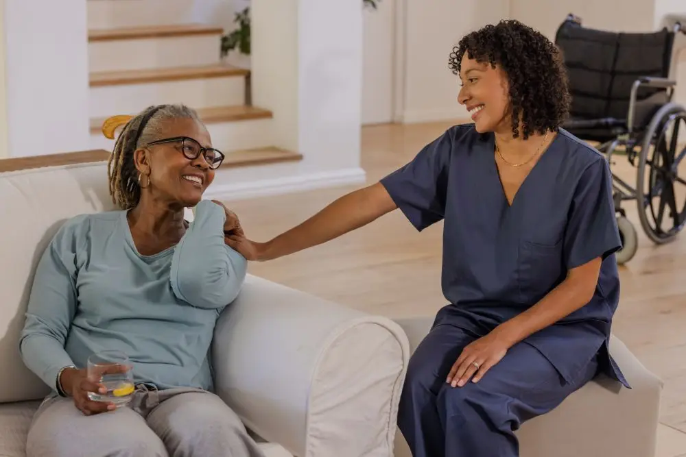 senior woman relaxing on couch with caregiver